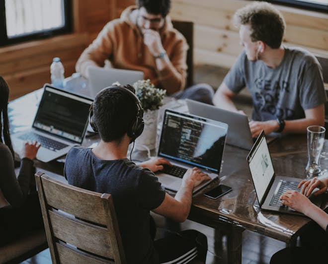 Group of young software engineers working on their laptops